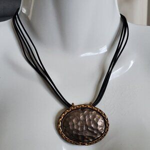 Four-strand cord necklace with hammered pendant